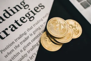 Close-up of Bitcoin coins placed on a document about trading strategies, symbolizing the debate over cryptocurrency as an inflation hedge or volatile investment.