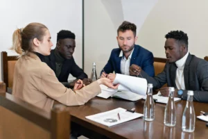"Group of lawyers discussing documents around a table, representing legal preparation for fighting insurance companies."