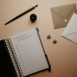 Open planner with a "New Year's Resolutions" to-do list surrounded by envelopes, a fountain pen, and decorative star earrings on a soft beige background — symbolizing shopper intent and planning behavior.