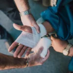 "Injured hand being treated and bandaged, representing physical harm in a motorcycle accident and the role of a lawyer in recovering compensation."