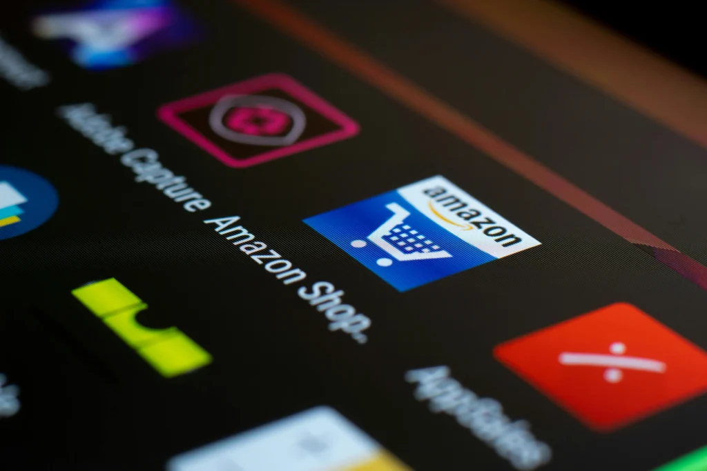"Close-up of a tablet screen displaying the Amazon shopping app, representing popular e-commerce platforms for launching a fitness business in 2025."