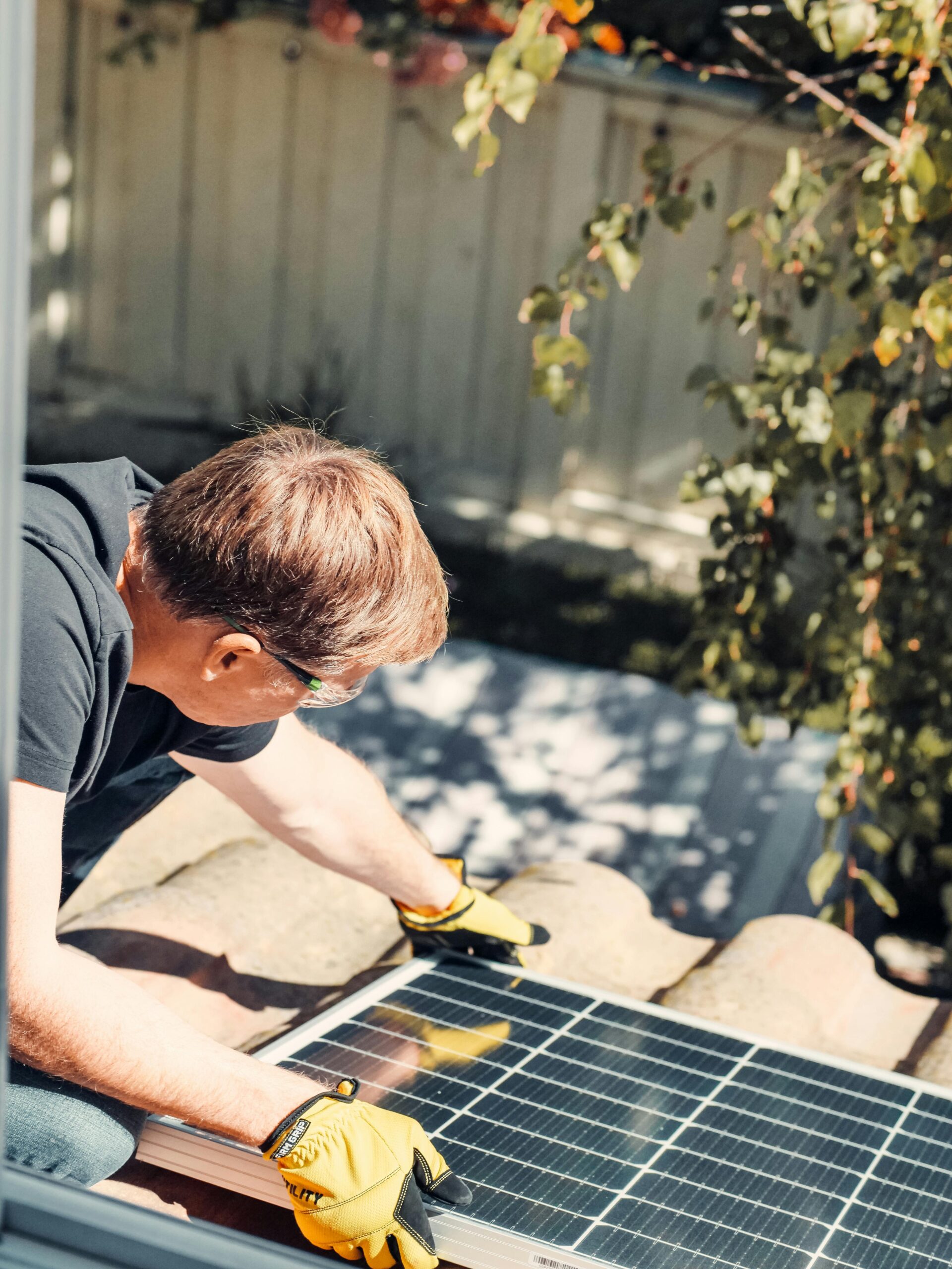 Worker installing solar panel on a rooftop — Green Tech & Sustainability: The Jobs of the Future