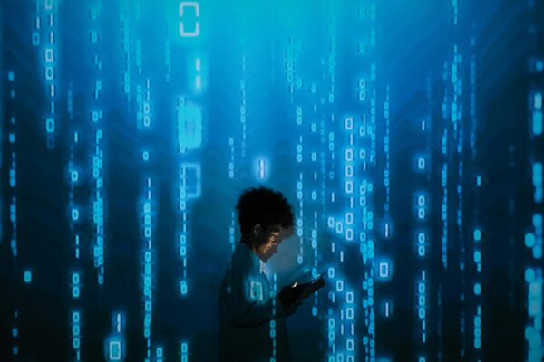 Young person using a tablet surrounded by digital binary code, symbolizing the future of jobs and essential tech skills in the AI-driven era of 2025.